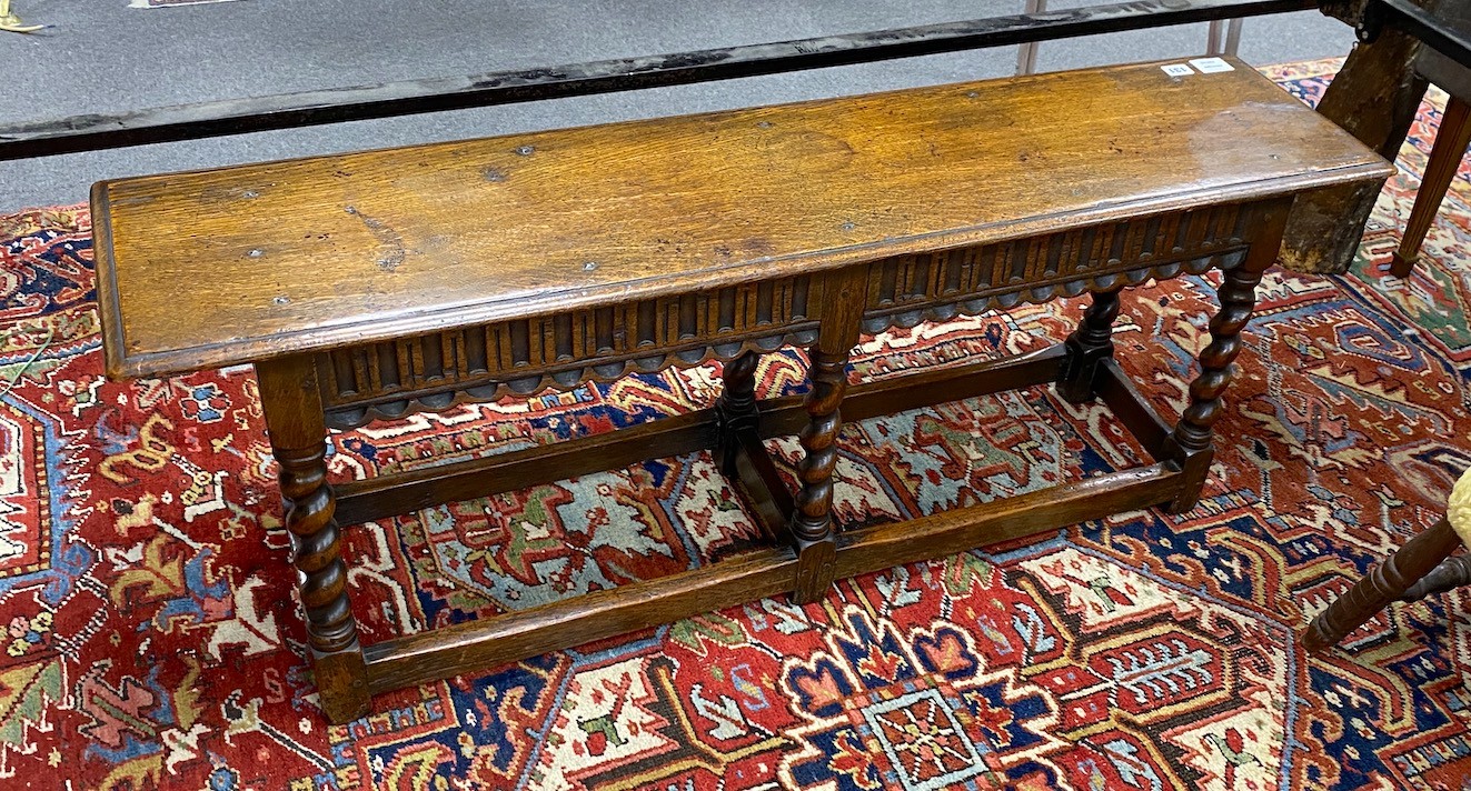 A 18th century style oak bench, with twist uprights, length 121cm, depth 30cm, height 46cm